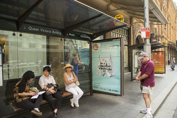 A piece from the project City Lights, with the secret "I'm a compulsive exaggerator," is displayed at a Sydney bus stop. Photo Courtesy of: Alphabet Studio.