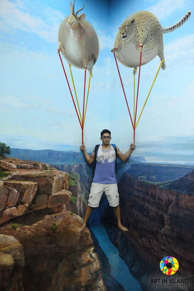 A visitor interacts with a painting at the Art in Island museum. Photo Credit: Art in Island.