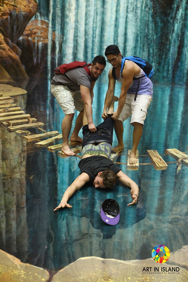 A visitor interacts with a painting at the Art in Island museum. Photo Credit: Art in Island.