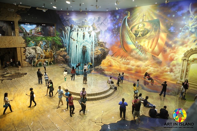 A visitor interacts with a painting at the Art in Island museum. Photo Credit: Art in Island.