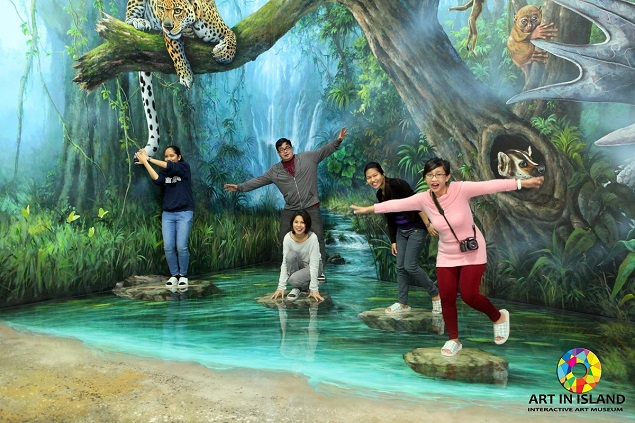 A visitor interacts with a painting at the Art in Island museum. Photo Credit: Art in Island.