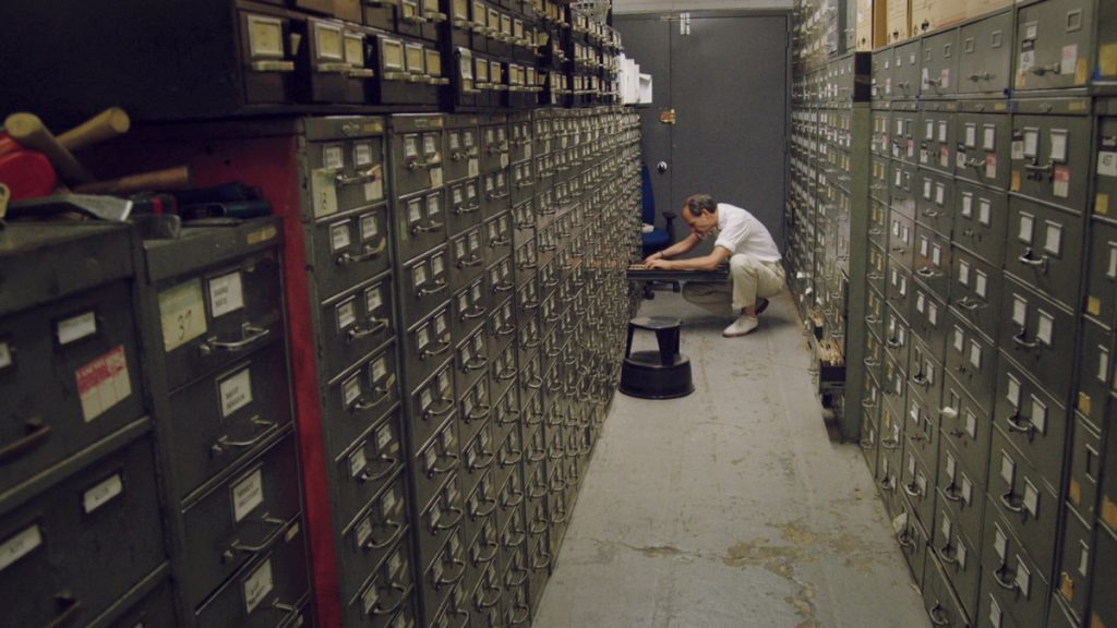 Last remaining archivist Jeff Roth searches the New York Times morgue. Photo Credit: Ben Wolf. 